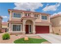 Two-story home with a red roof, red garage doors, and manicured lawn at 6558 Musette Ave, Las Vegas, NV 89139