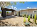 Inviting single-story home with a covered carport, gravel yard, desert landscaping, and a cozy front porch at 67 Oklahoma Dr, Henderson, NV 89015