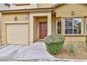 A well maintained exterior, with manicured shrubs, an attached garage and warm exterior tones at 6739 Twisted Wood Dr, Las Vegas, NV 89148