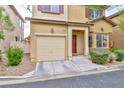 Inviting exterior showcasing a well-maintained front yard, warm exterior tones and attached garage at 6739 Twisted Wood Dr, Las Vegas, NV 89148