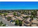 Overview of homes in a suburban neighborhood featuring tiled roofs and desert landscaping on a clear, sunny day at 7625 Raven Hills Dr, Las Vegas, NV 89149