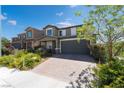 Charming two-story home with landscaped yard and brick driveway at 7732 Bandon Cliffs St, North Las Vegas, NV 89084
