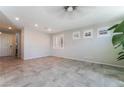 Spacious living room with tile floors, recessed lighting and modern ceiling fan at 7732 Bandon Cliffs St, North Las Vegas, NV 89084
