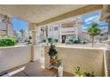 A cozy outdoor patio space with stucco walls and gated access, offering a private retreat at 7952 Diamond Rock Way # 102, Las Vegas, NV 89128