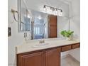 Bathroom with large mirror, drop-in sink, and view to bedroom at 8070 W Russell Rd # 1036, Las Vegas, NV 89113