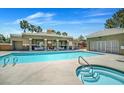 Community swimming pool and hot tub on a sunny day at 8070 W Russell Rd # 1036, Las Vegas, NV 89113