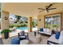 Inviting covered patio with stylish seating area, ceiling fan, and view of the refreshing pool at 8113 Gothic Ave, Las Vegas, NV 89117