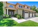 Well maintained two-story home featuring stone accents, a three-car garage, and desert landscaping at 8113 Gothic Ave, Las Vegas, NV 89117