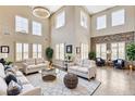 Bright living room featuring high ceilings, a decorative chandelier, and elegant furnishings at 8113 Gothic Ave, Las Vegas, NV 89117