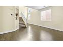 Inviting living room with hardwood floors, a staircase, and plenty of space at 8221 Stoneheather Ct, Las Vegas, NV 89117