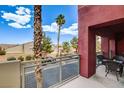 Inviting balcony with outdoor seating and view of street at 83 E Agate Ave # 207, Las Vegas, NV 89123
