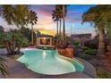 Beautiful backyard pool with rock waterfall feature and a covered gazebo at 9008 Sawhill Pond St, Las Vegas, NV 89131