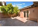 Private backyard featuring a brick-paved patio area with mature trees at 9025 Loggers Mill Ave, Las Vegas, NV 89143