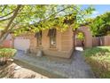Beautiful exterior of a home with an arched gate leading to a private courtyard and a two-car garage at 9025 Loggers Mill Ave, Las Vegas, NV 89143