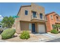 Street view of a stucco home featuring a balcony above a one-car garage at 9431 Mad Dog St, Las Vegas, NV 89178