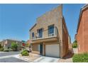 Exterior view of home with balcony and one-car garage, and desert landscaping at 9431 Mad Dog St, Las Vegas, NV 89178