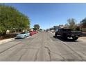 Residential street featuring a variety of parked cars under a clear sky at , Las Vegas, NV 89110