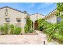 Inviting front entrance featuring stone pathway, desert landscaping and a covered entryway at 10156 Kearney Hill Pl, Las Vegas, NV 89144