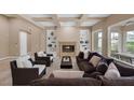 Inviting living room with built-in shelving, fireplace, and comfortable seating arrangement at 10156 Kearney Hill Pl, Las Vegas, NV 89144