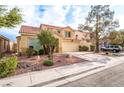 Two-story home with desert landscaping, an attached two-car garage, and a red tile roof at 1742 Ashburn Dr, North Las Vegas, NV 89032