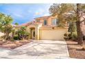 Two-story home with desert landscaping, an attached two-car garage, and a red tile roof at 1742 Ashburn Dr, North Las Vegas, NV 89032