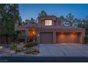 Charming home featuring a two-car garage, desert landscaping, and a covered front porch at 2108 Inverness Dr, Henderson, NV 89074