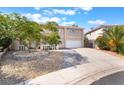 Charming home featuring a well-maintained front yard with desert landscaping and a spacious driveway at 2874 Avanti Ln, Henderson, NV 89074