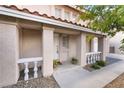 Inviting front porch with decorative columns and potted plants at the entrance at 2874 Avanti Ln, Henderson, NV 89074