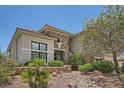 Stunning two-story home exterior with stone accents, manicured landscaping, and a welcoming entrance at 3042 Hammerwood Dr, Las Vegas, NV 89135