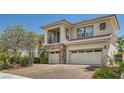 Elegant two-story home with a three-car garage, stone accents, and a well-maintained driveway at 3042 Hammerwood Dr, Las Vegas, NV 89135