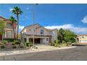 Attractive two-story home featuring a three-car garage, mature trees, and well-maintained landscaping at 3192 Tullio Way, Henderson, NV 89052