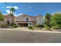 Attractive two-story home featuring a three-car garage, mature trees, and well-maintained landscaping at 3192 Tullio Way, Henderson, NV 89052