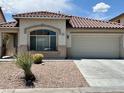 A one-story home that features desert landscaping, a two-car garage, and a tiled roof at 3261 Monaco Shores Dr, Las Vegas, NV 89117