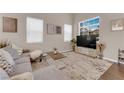 Cozy living room with large windows, a plush gray sofa, and stylish decor at 3659 Gerri Bay Ln, Las Vegas, NV 89147
