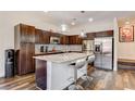 Modern kitchen with granite countertops, stainless steel appliances, and barstool seating at 3839 Zodiacal Light St, Las Vegas, NV 89129