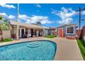 Backyard oasis featuring a sparkling pool, patio area, and a covered porch perfect for outdoor living and entertaining at 4419 Lorna Pl, Las Vegas, NV 89107