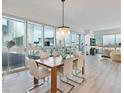 Chic dining area with modern chandelier, dining set and expansive windows showcasing impressive city views at 4471 Dean Martin Dr # 1109, Las Vegas, NV 89103