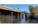 Home exterior featuring stucco siding and mature desert landscaping at 5353 Hollow Brook Ave, Las Vegas, NV 89142