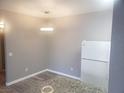 Eat-in kitchen area with granite countertops, white appliances, and updated flooring at 5655 E Sahara Ave # 2068, Las Vegas, NV 89142