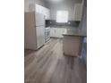 The kitchen has granite countertops and new gray flooring at 5655 E Sahara Ave # 2068, Las Vegas, NV 89142