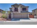 View of the exterior of the home showing the facade with shutters and a balcony on the second story at 5712 French Lace Ct, North Las Vegas, NV 89081