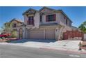 Two-story stucco home featuring a spacious three-car garage and wrought iron fence at 5712 French Lace Ct, North Las Vegas, NV 89081