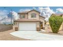 Exterior view of a two-story residence featuring a tile roof and an attached two-car garage at 5816 Glory Canyon Way, Las Vegas, NV 89142