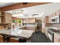 Modern kitchen boasts granite countertops, stainless steel appliances, and a breakfast bar for casual dining at 6612 Elton Ave, Las Vegas, NV 89107