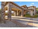 Stunning stone estate with a porte cochere and meticulous landscaping at 670 Du Fort Ave, Henderson, NV 89002