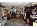 Cozy living room with hardwood floors, a gray sofa, and dark wood furnishings at 6772 Oak Mist St, Las Vegas, NV 89139