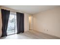 Neutral bedroom with gray floors and patio access through sliding glass door at 6861 Tamarus St # 203, Las Vegas, NV 89119