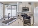 Well-lit kitchen with stainless steel appliances and granite countertops at 7633 Raven Hills Dr, Las Vegas, NV 89149