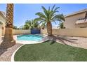 Backyard pool and palm tree create a desert oasis feel at 7633 Raven Hills Dr, Las Vegas, NV 89149