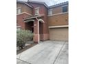 Exterior view featuring attached garage and a well-maintained landscape at 7977 Delft Blue St, Las Vegas, NV 89139
